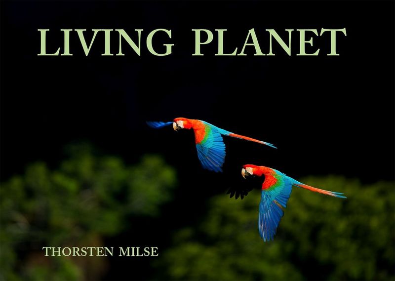 Thorsten Milse's Living Planet hdbook, with red macaws in flight on the front cover.