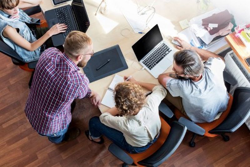 Work professionals in a room in a meeting