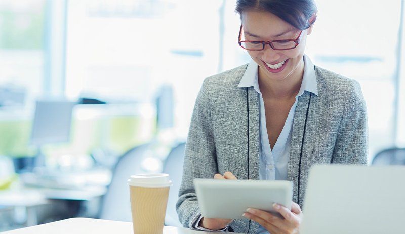 Woman smiling at tablet