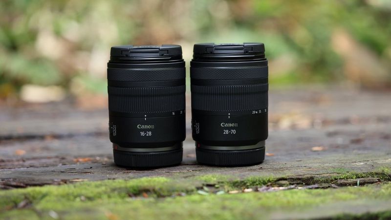 A Canon RF 16-28MM F2.8 IS STM and a Canon RF 28-70mm F2.8 IS STM lens side-by-side.