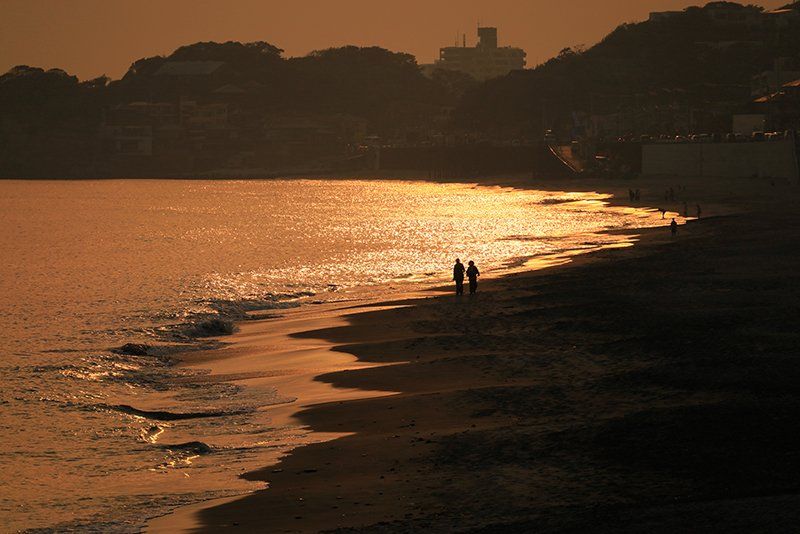 couple walk along beach