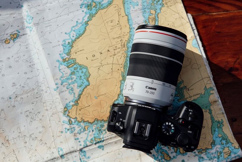 A Canon EOS R6 with a Canon RF 70-200MM F4L IS USM lens attached, sitting on a map of Iona.
