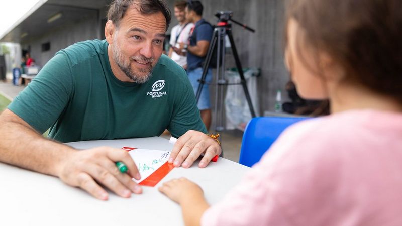 David Gerard talks to a young girl during an event at Rugby World Cup 2023