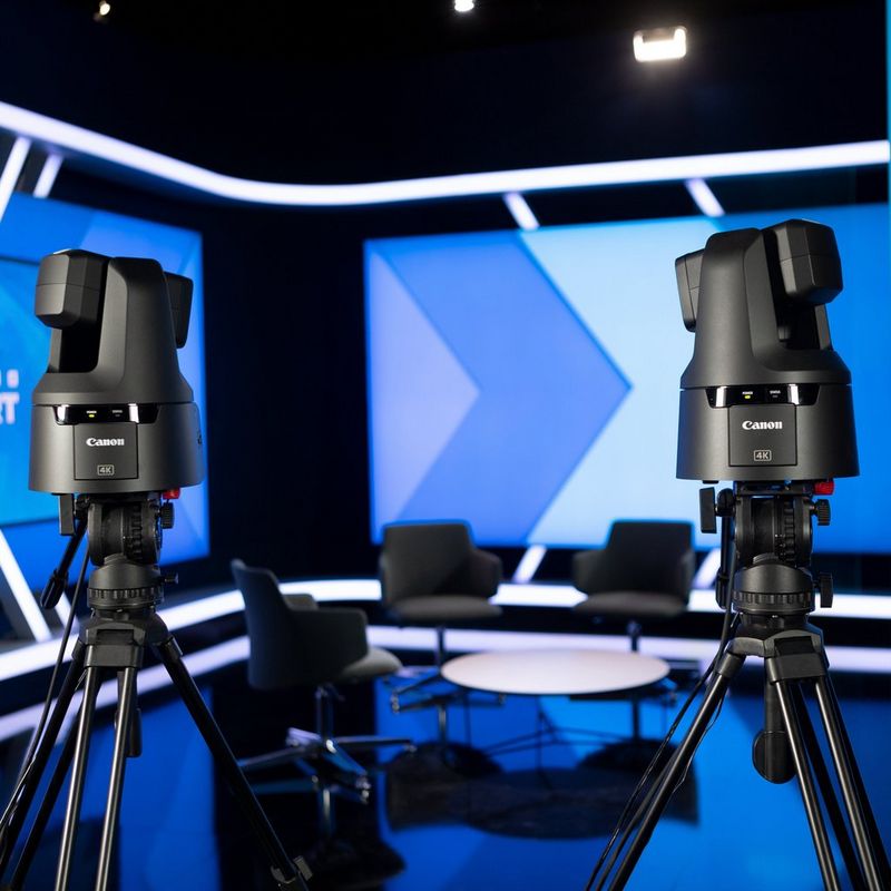 Two Canon PTZ cameras positioned for live broadcast in a sports studio.