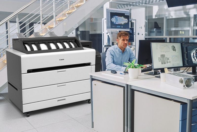 Architect at desk with imagePROGRAF TZ series large format printer