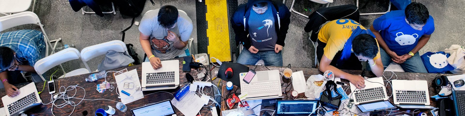 bird's-eye view of a group of people working on their laptops. 