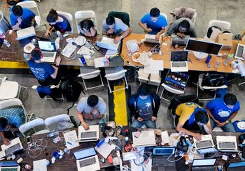 a bird's-eye view of group of people working on their laptops 