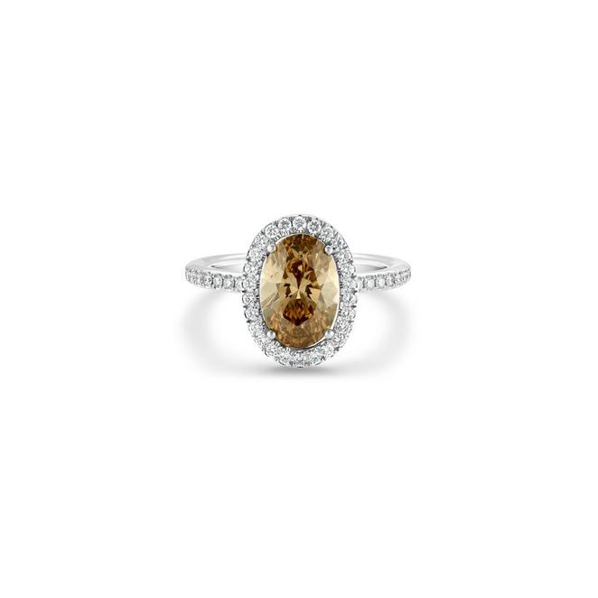 Aura solitaire ring with a fancy colour oval-shaped diamond in white and yellow gold