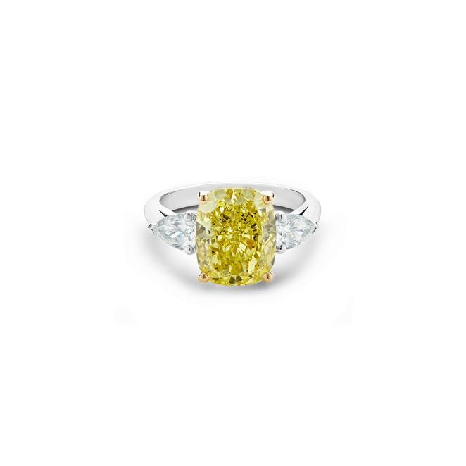 DB Classic solitaire ring with a fancy intense yellow cushion-cut diamond and pear-shaped side diamonds in yellow gold and platinum