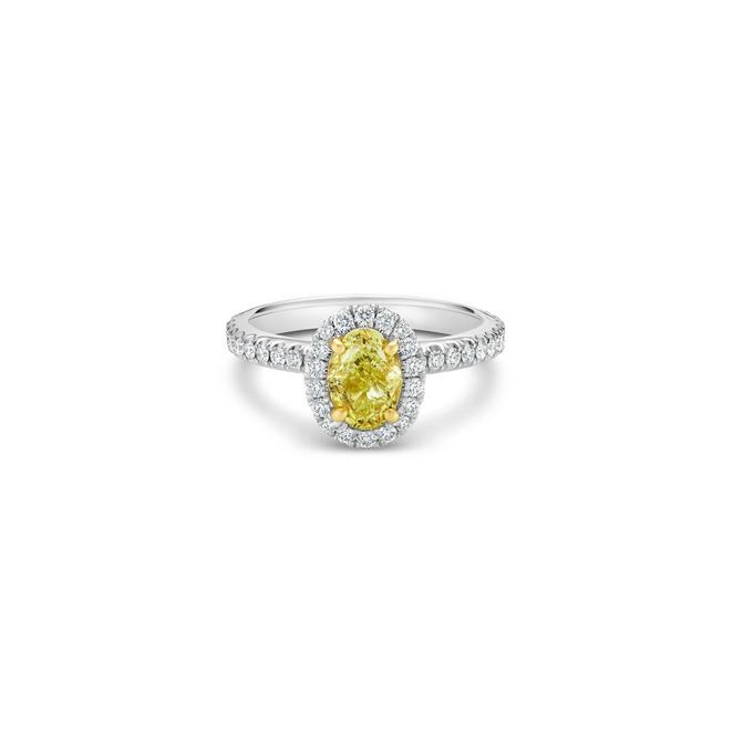 Aura solitaire ring with a fancy yellow oval-shaped diamond in platinum and yellow gold