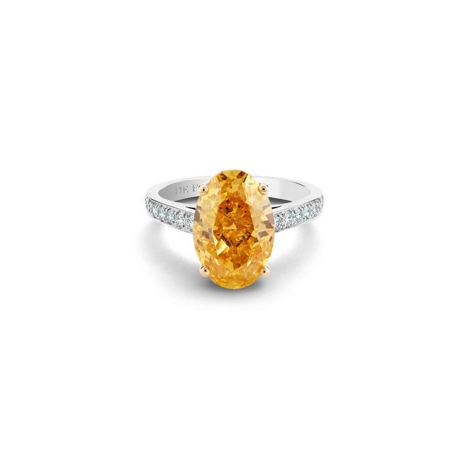 Old Bond Street solitaire ring with a fancy vivid yellow orange oval-shaped diamond in platinum