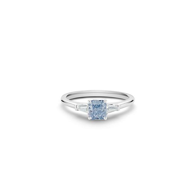 DB Classic solitaire ring with a fancy intense blue radiant-cut diamond and tapered baguette-cut side diamonds in platinum