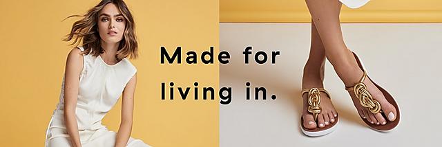 Women wearing Twiss Gold Leather Toe-post sandals.  featuring two large twisted braid.