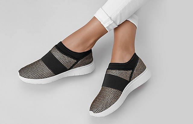 Fitflop Knitted black and gold slip-on sneakers.