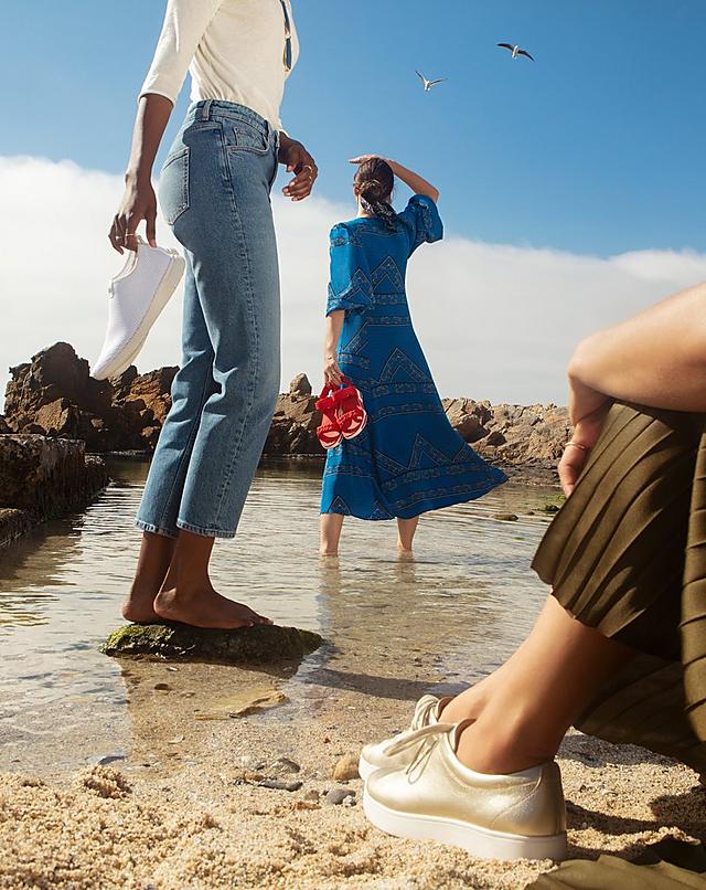 Women on South African Beach wearing Fitflop Footwear, Sandals and Sneakers.