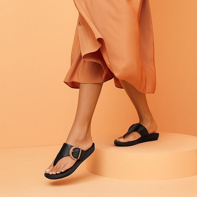 Fitflop leather toe-thongs in black with buckle detail.