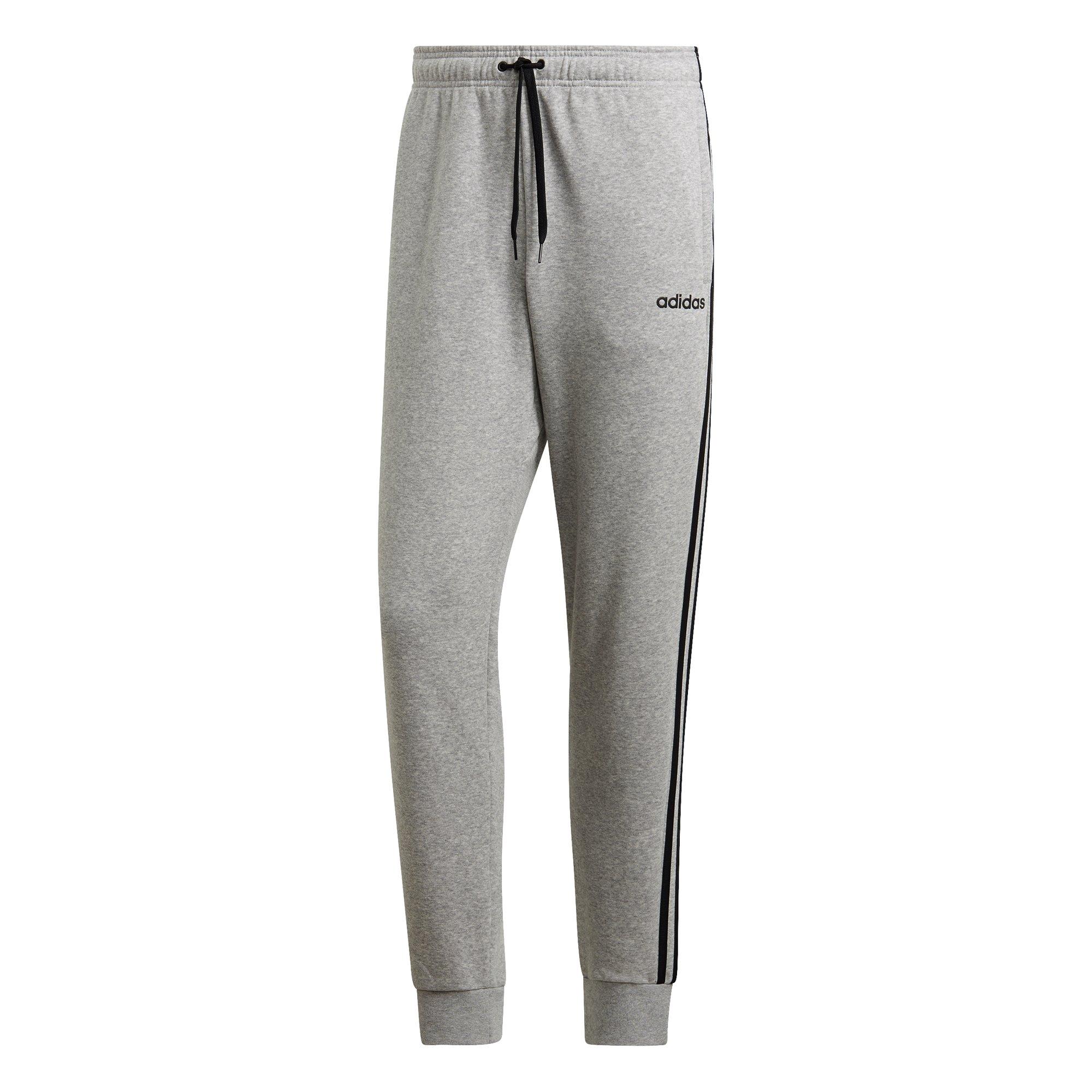 grey adidas pants with black stripes