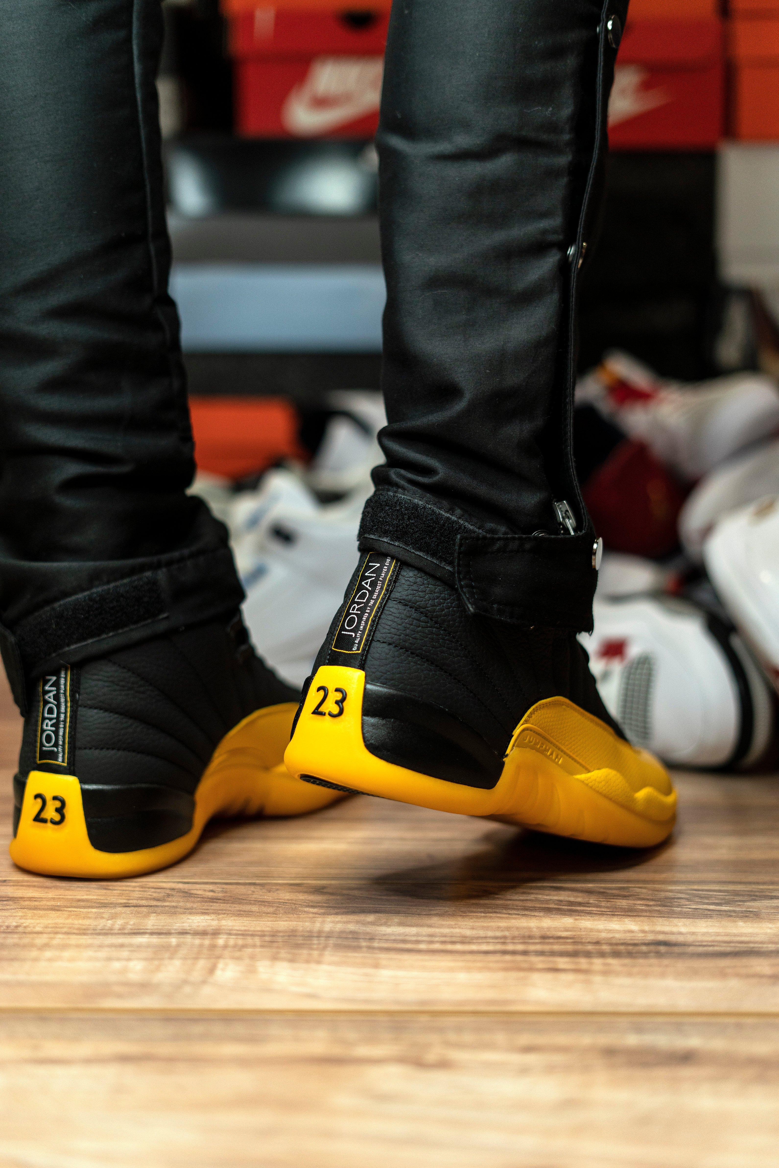 jordan 12 black and yellow on feet