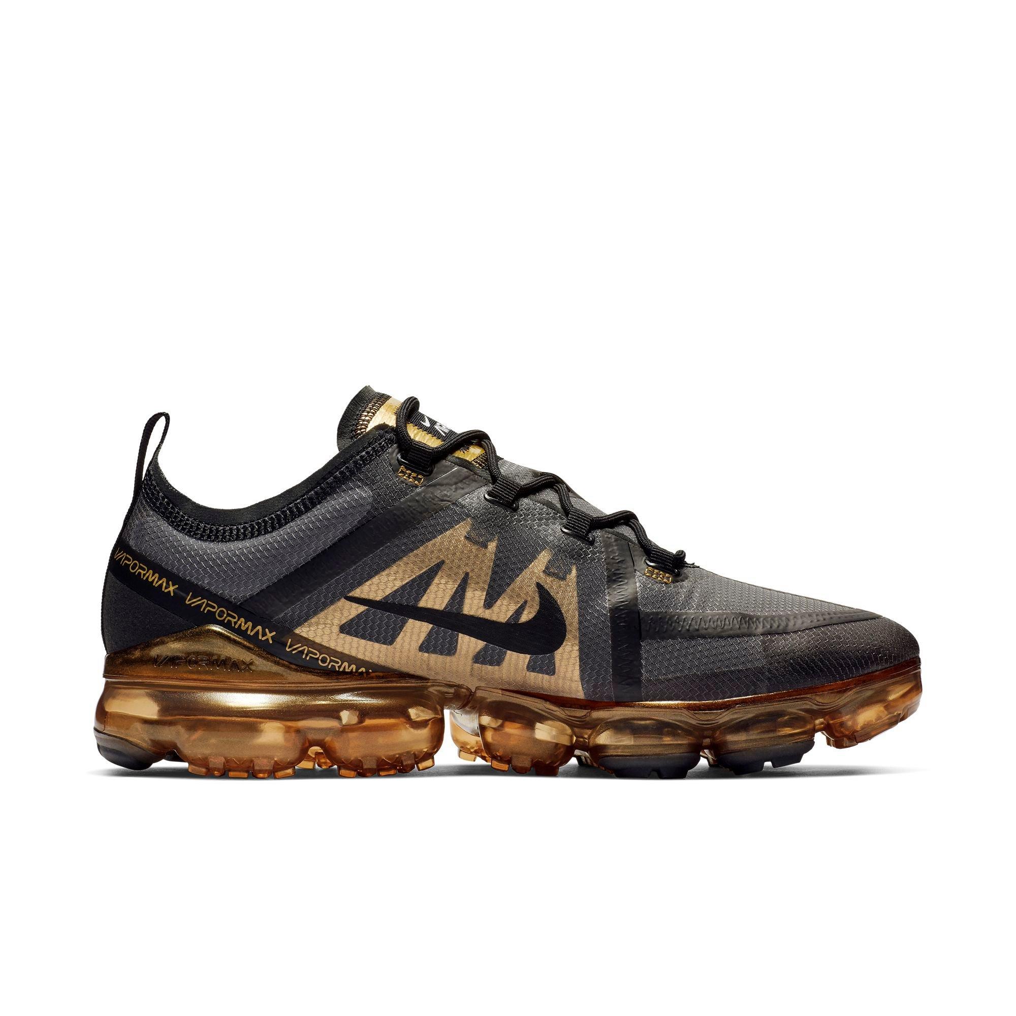 nike gold and black sneakers