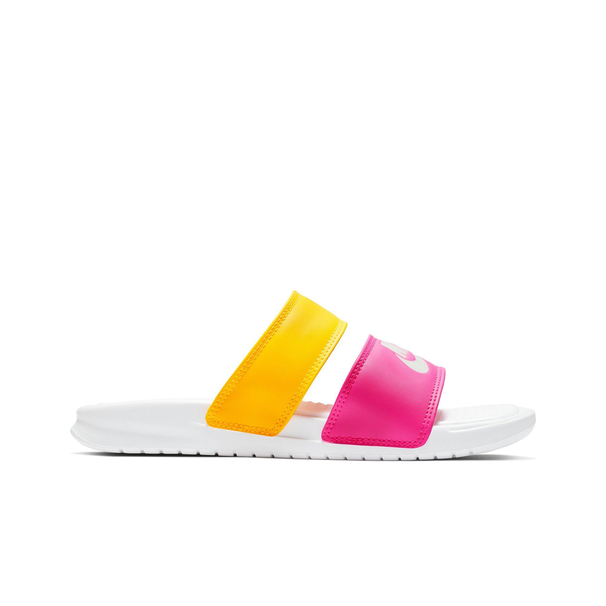 pink and yellow nike slides