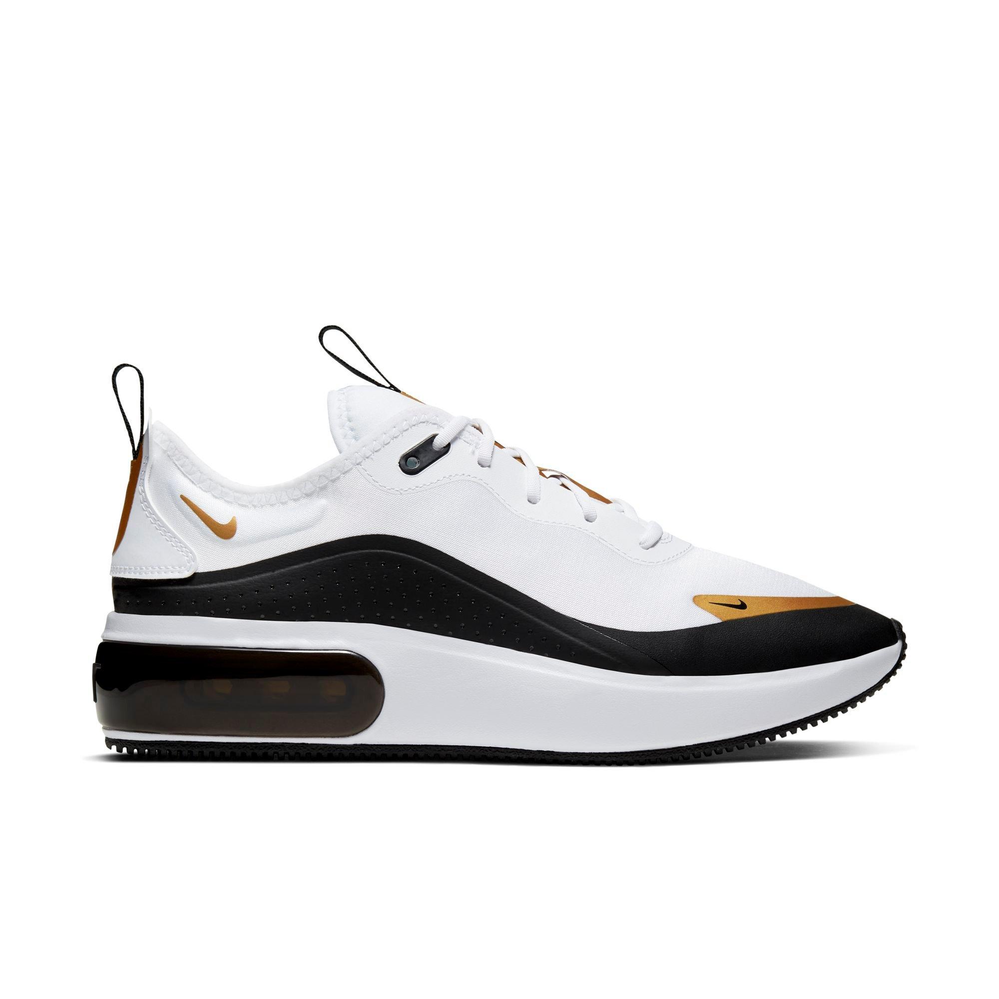 gold white and black nike shoes