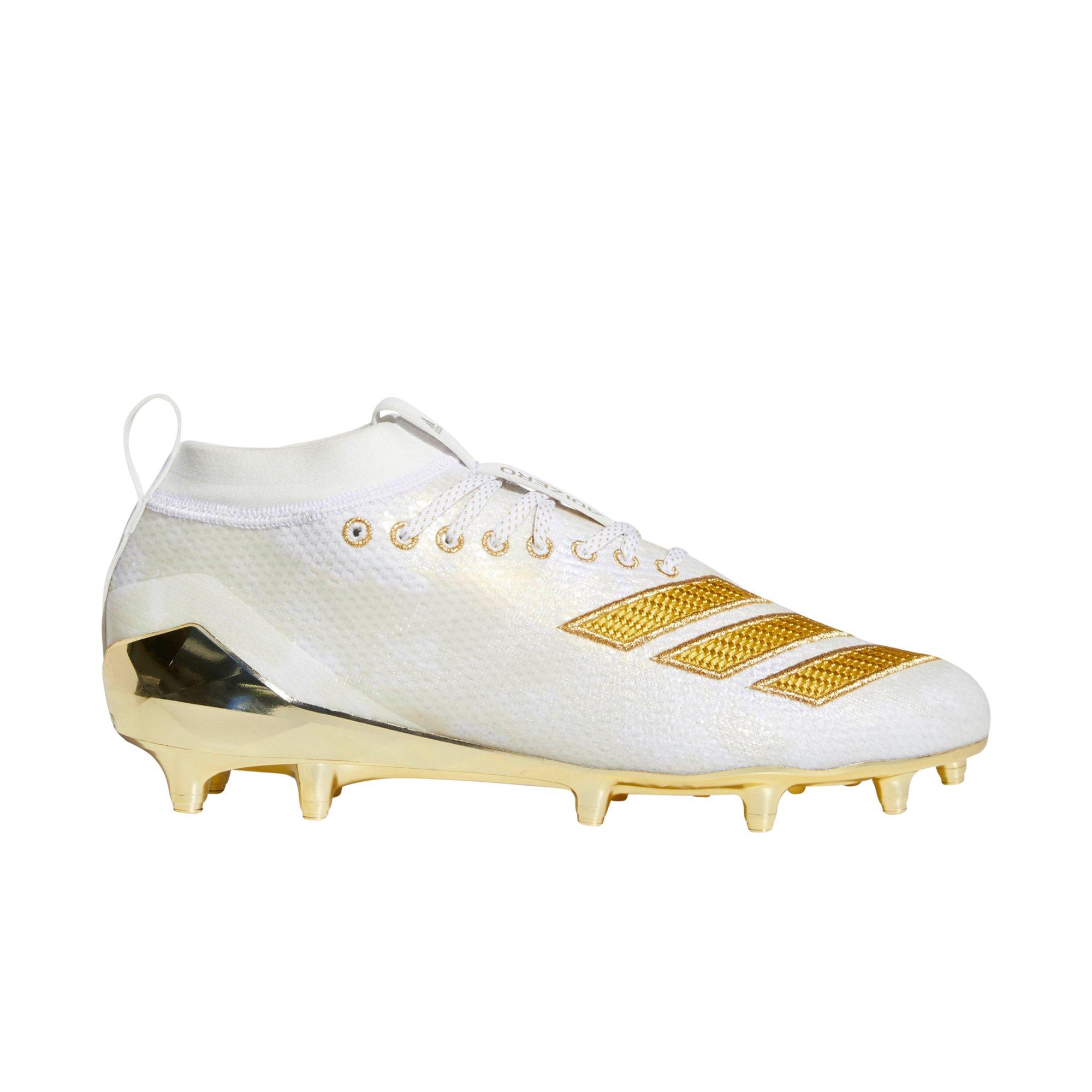 white and gold football cleats