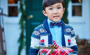 Boy in a holiday sweater holiday a present