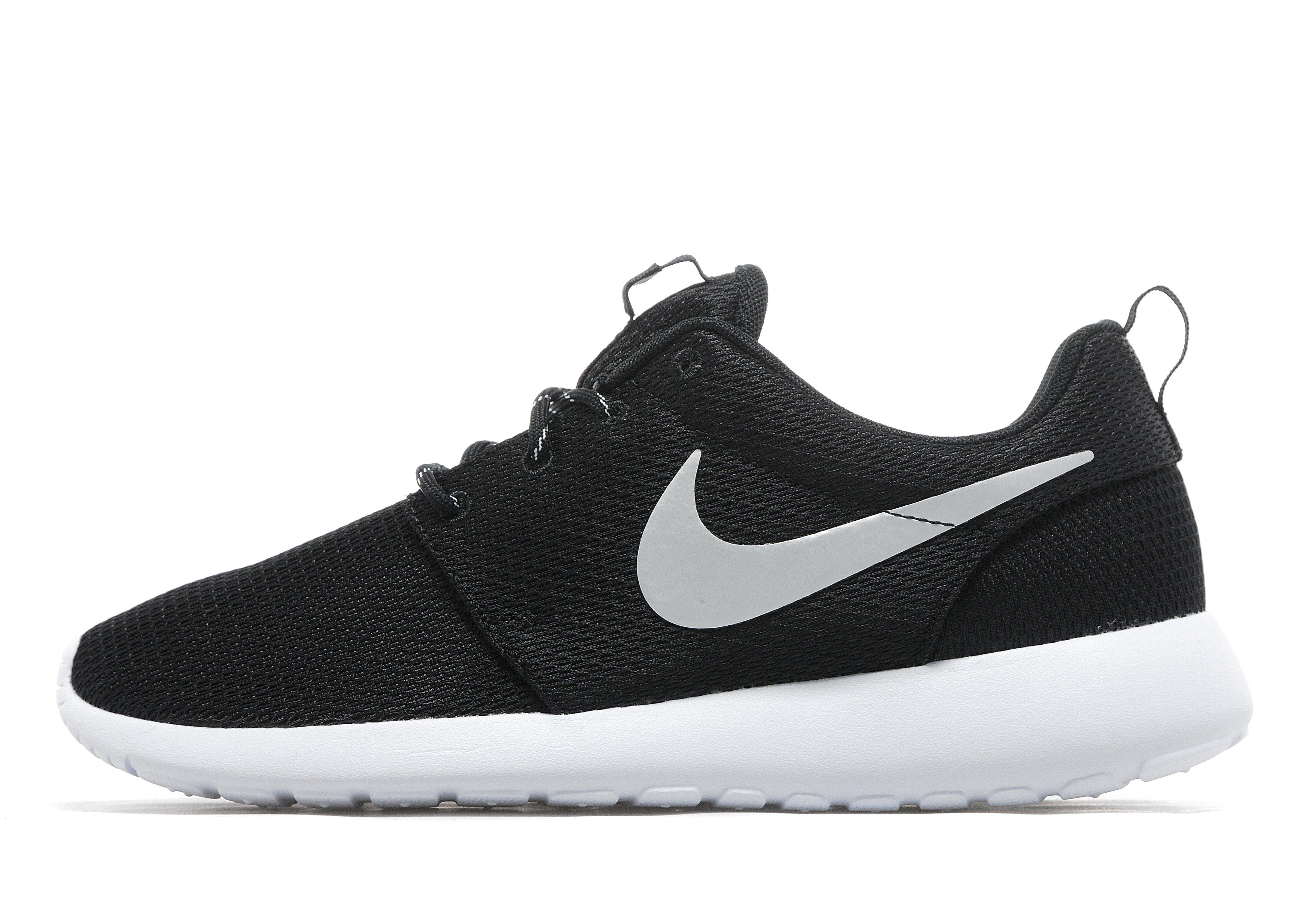 black nike shoes with white tick