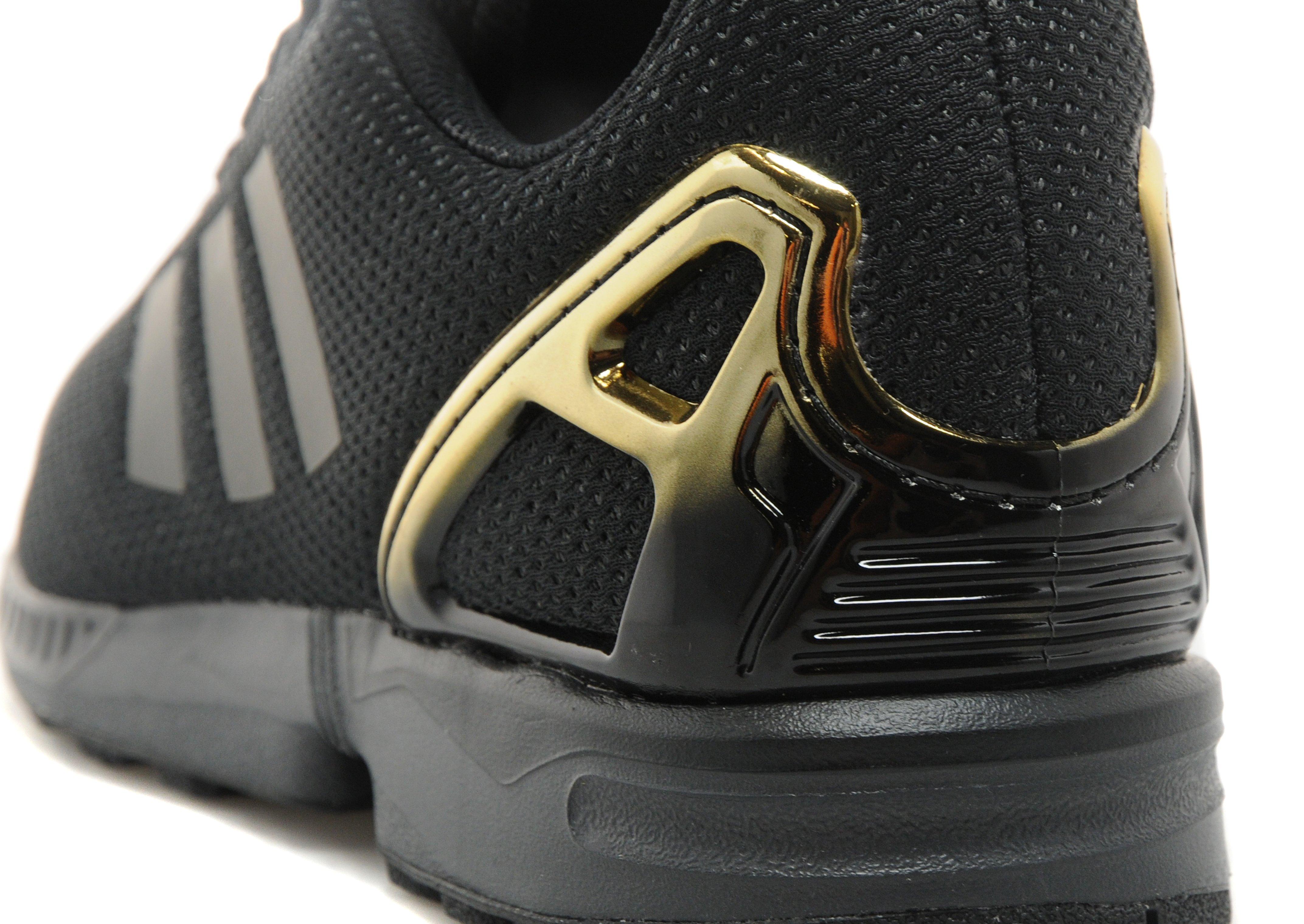 black and gold adidas flux