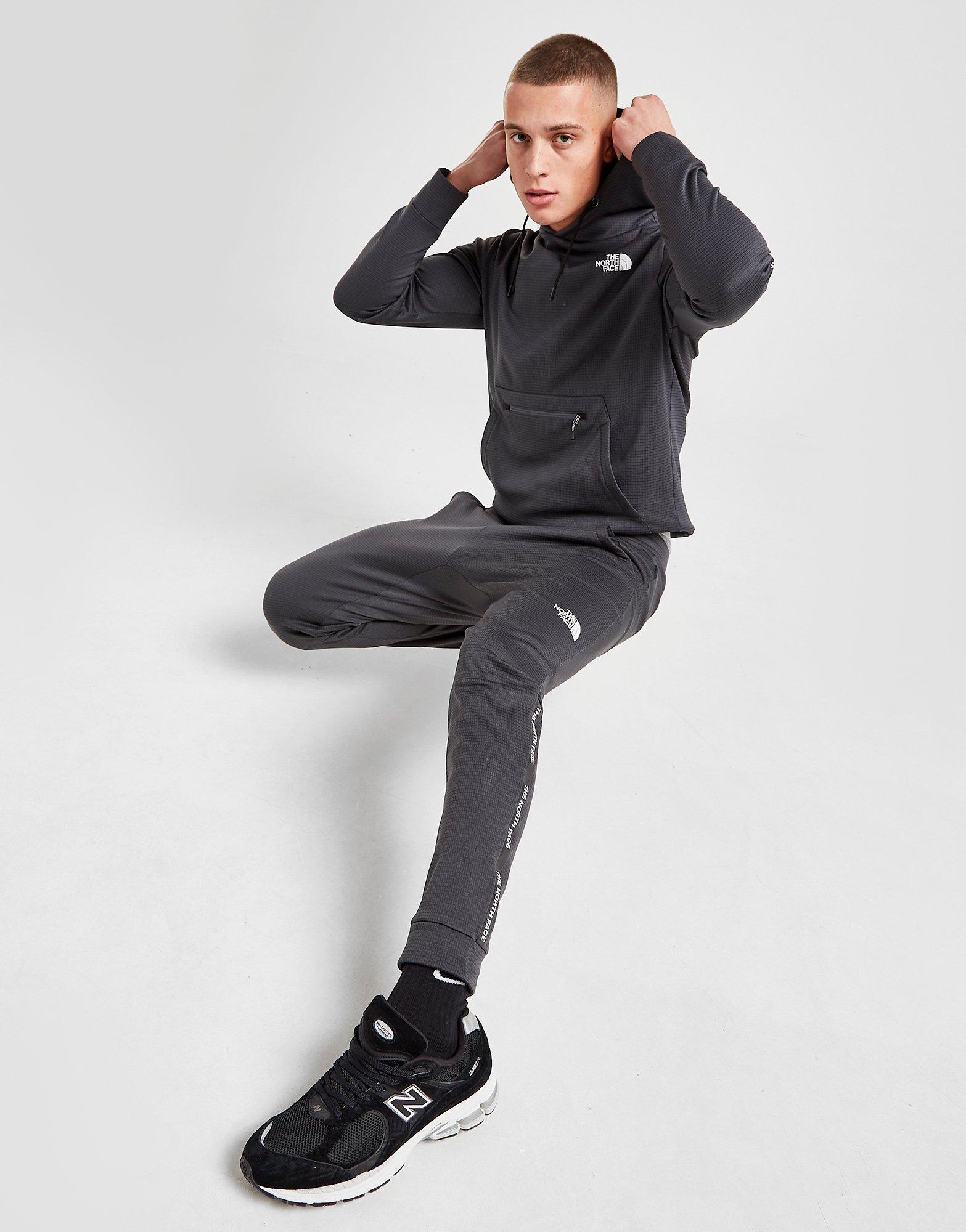 Pantaloni pentru bărbați THE NORTH FACE PANTALONI  TRAIN N LOGO TRACK PANTS NF0A5IJM0C51 Gri