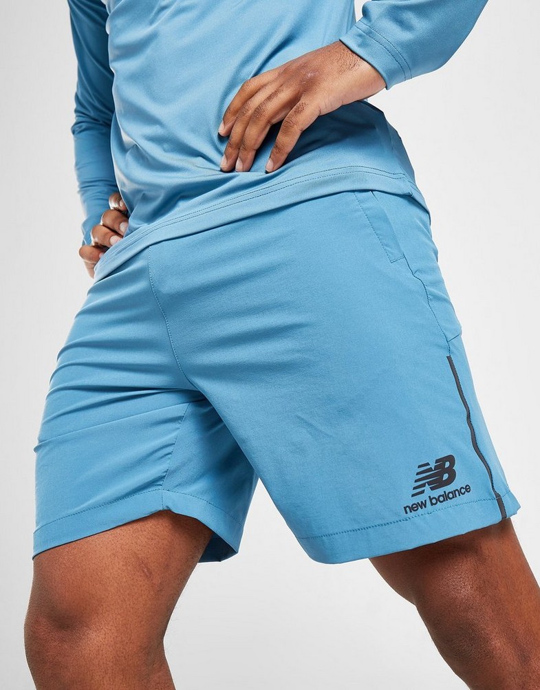 Krótkie spodenki, szorty męskie NEW BALANCE SZORTY WOVEN SHORTS MS21600SGD Niebieski