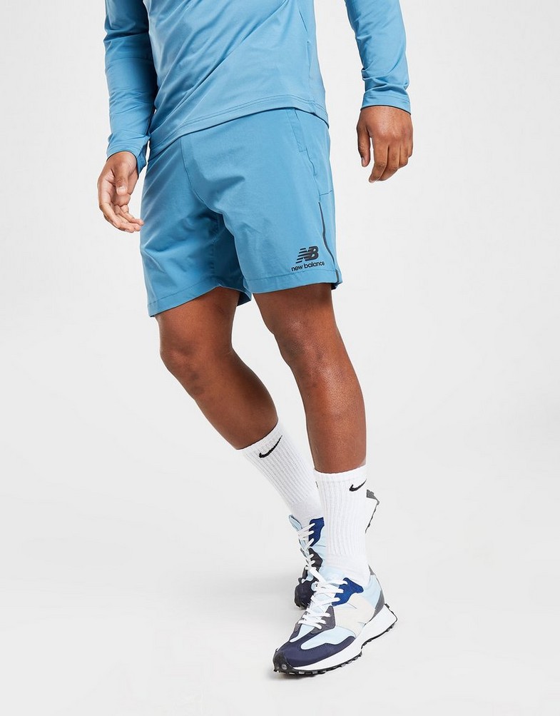 Krótkie spodenki, szorty męskie NEW BALANCE SZORTY WOVEN SHORTS MS21600SGD Niebieski
