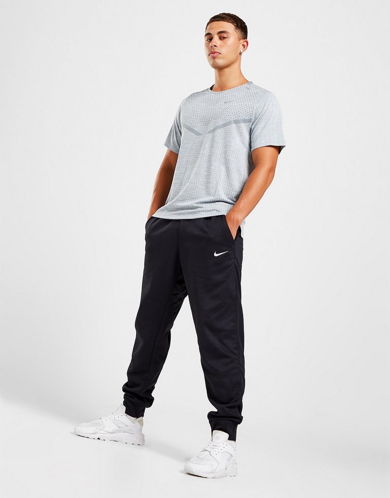 Pánské kalhoty NIKE KALHOTY  M NK TF PANT TAPER DQ5405-010 Černá