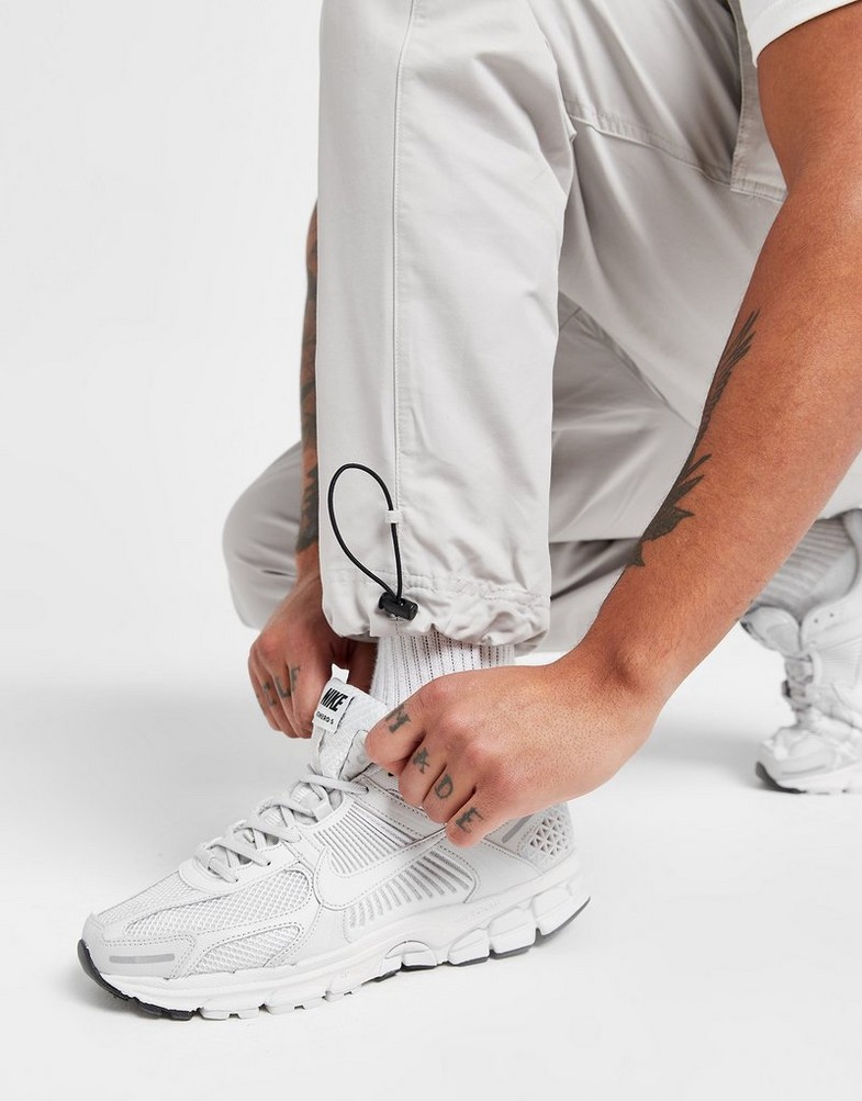 NIKE SPODNIE PLAYER WVN PANT LT ORE PANTS DX2033-012 Beżowy