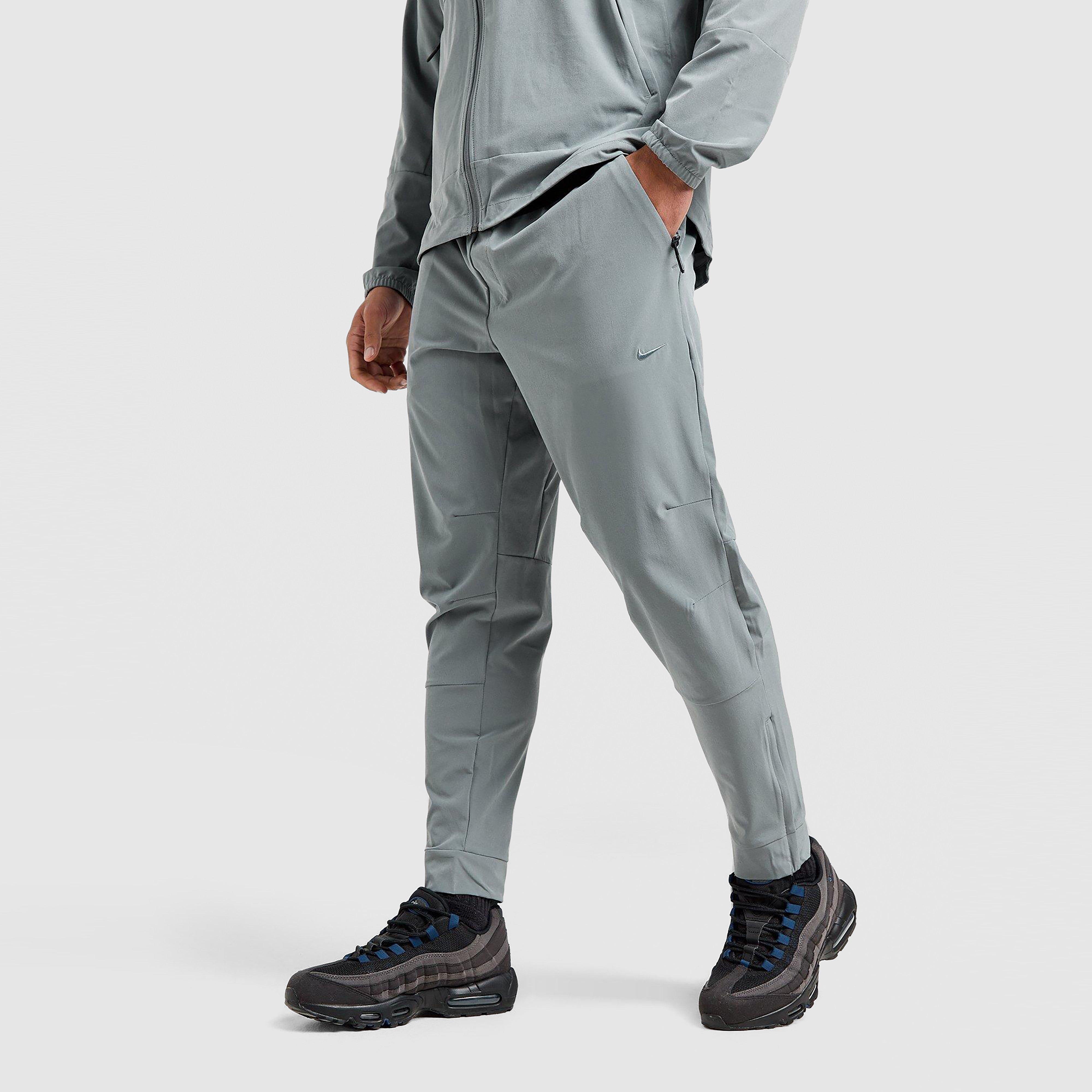 NIKE SPODNIE M NK DF UNLIMITED PANT TPR