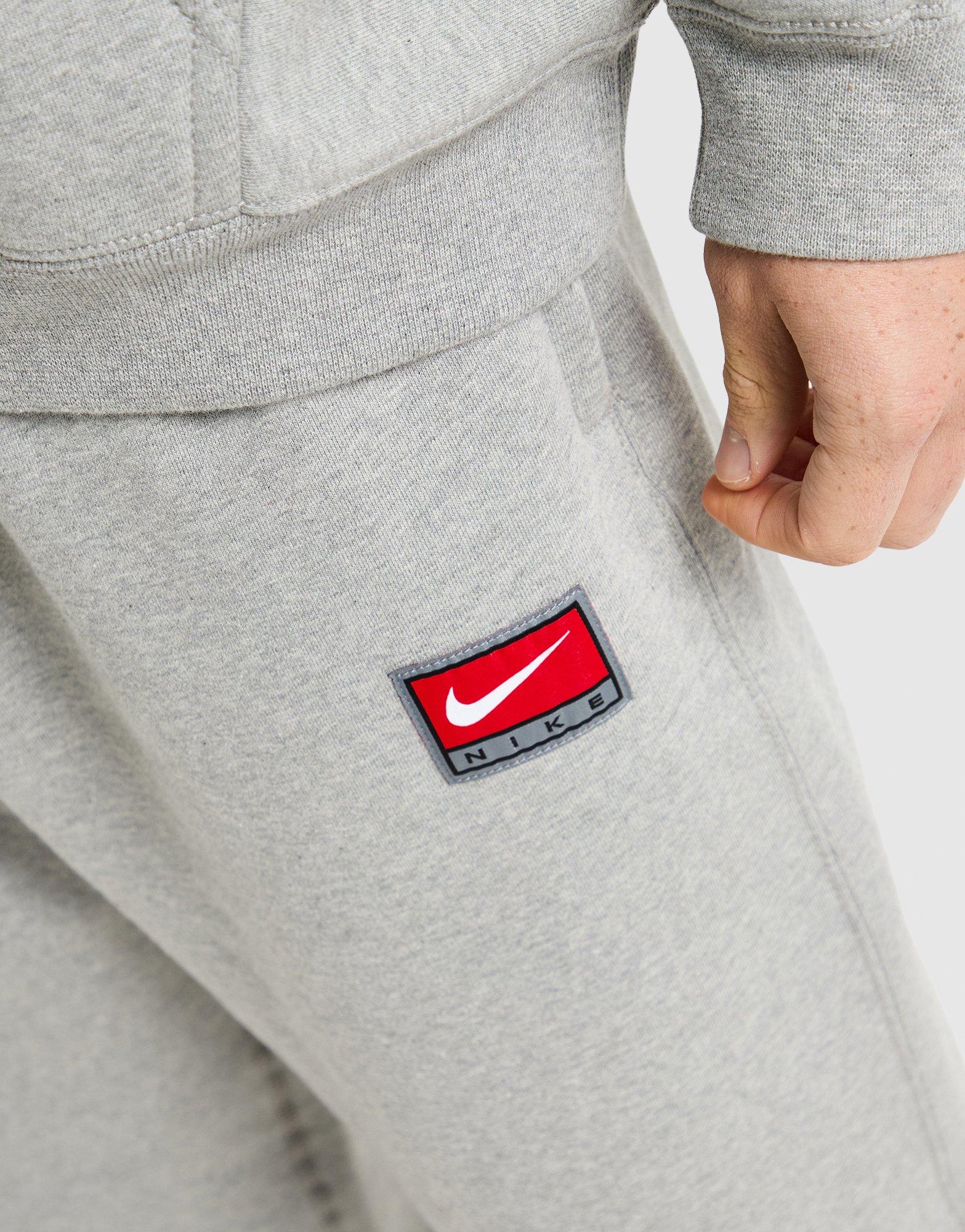 Pánske nohavice NIKE NOHAVICE  M NL SOLO SWSH BB OH PANT GFX IO0675-063 Sivá