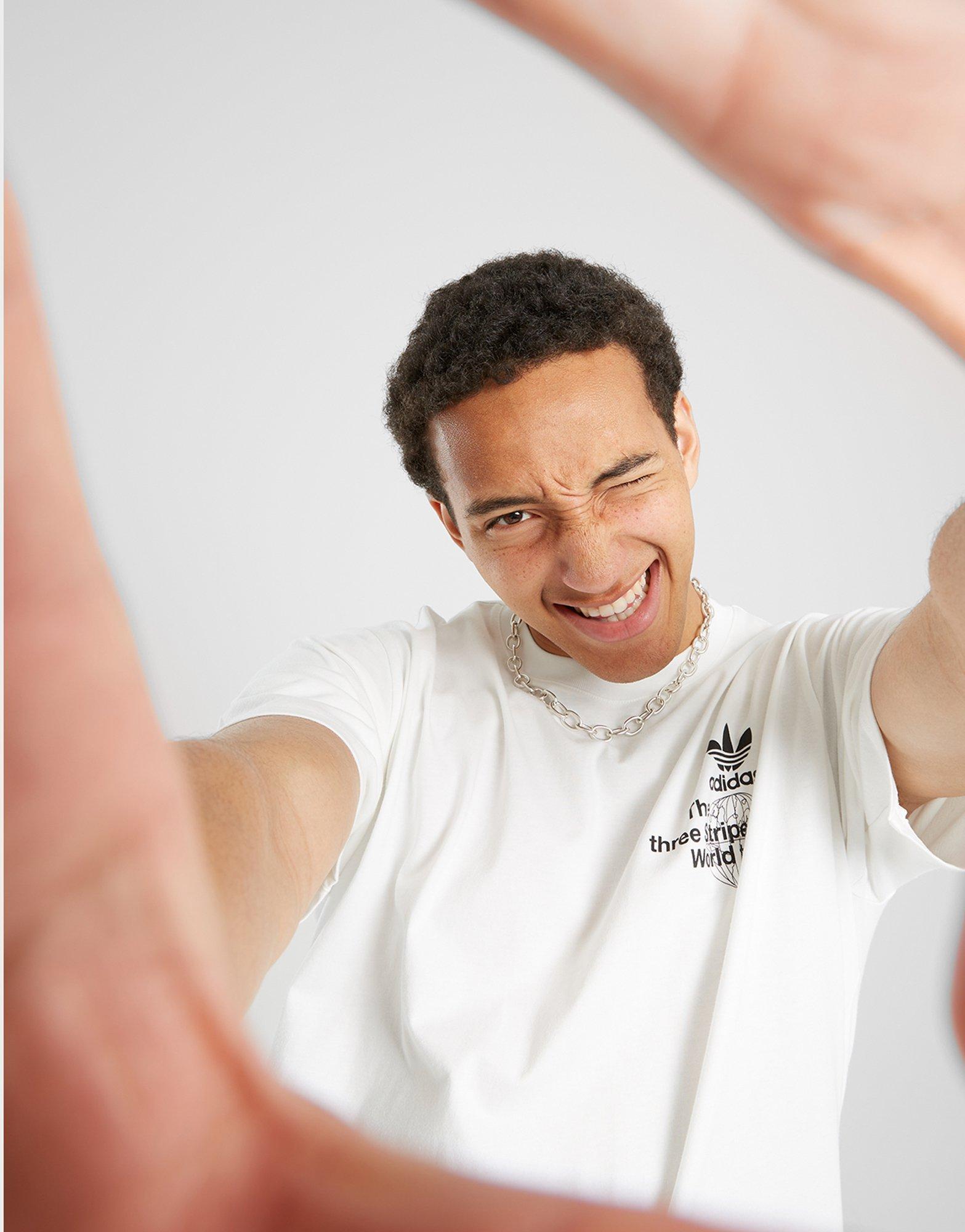 Vyriški marškiniai ADIDAS MARŠKINĖLIAI BAND TEES - WORLD TOUR ORIGINALS POLY CO JE4259 Balta