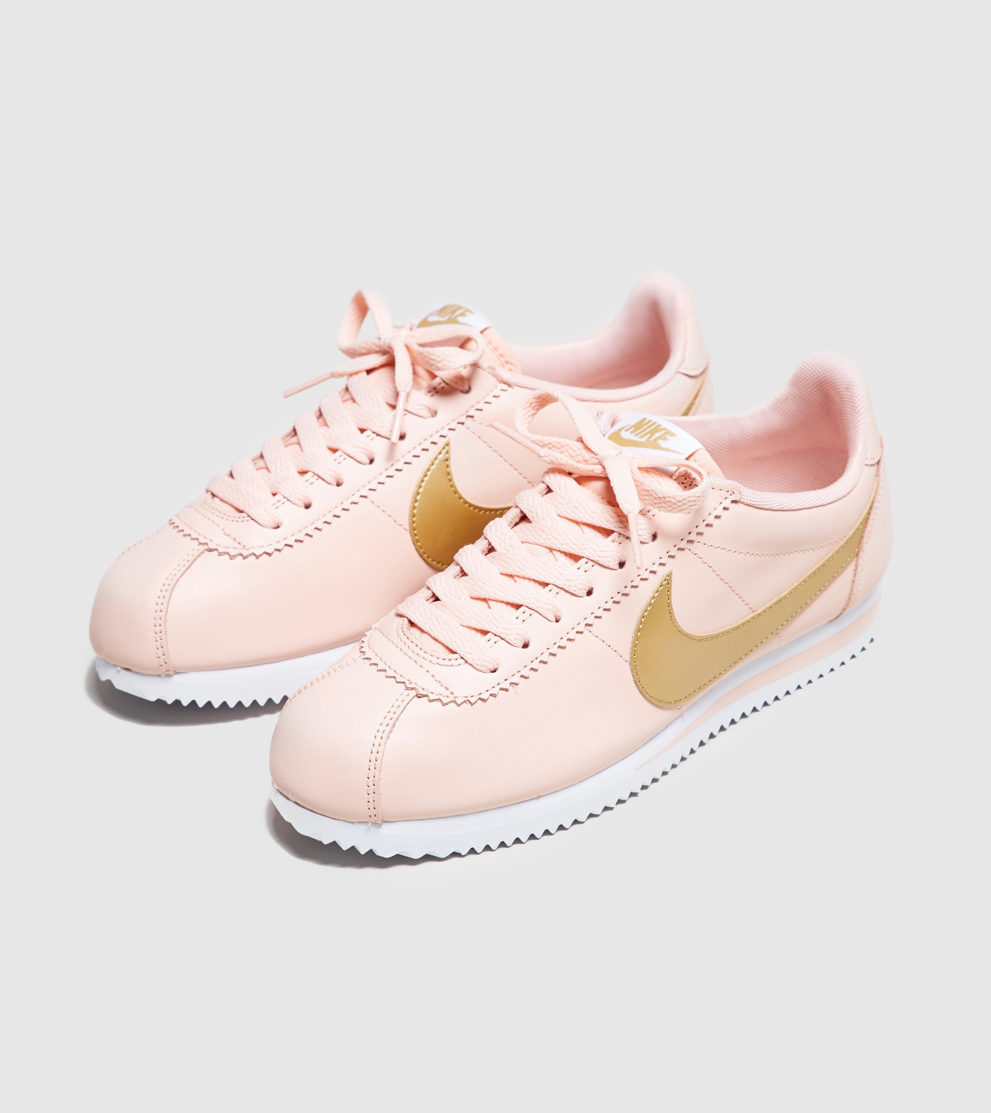 pink nike cortez with gold swoosh