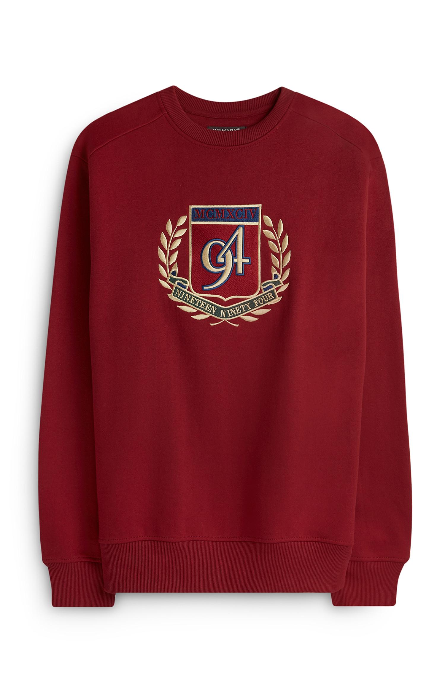 Roter Pullover mit Wappen