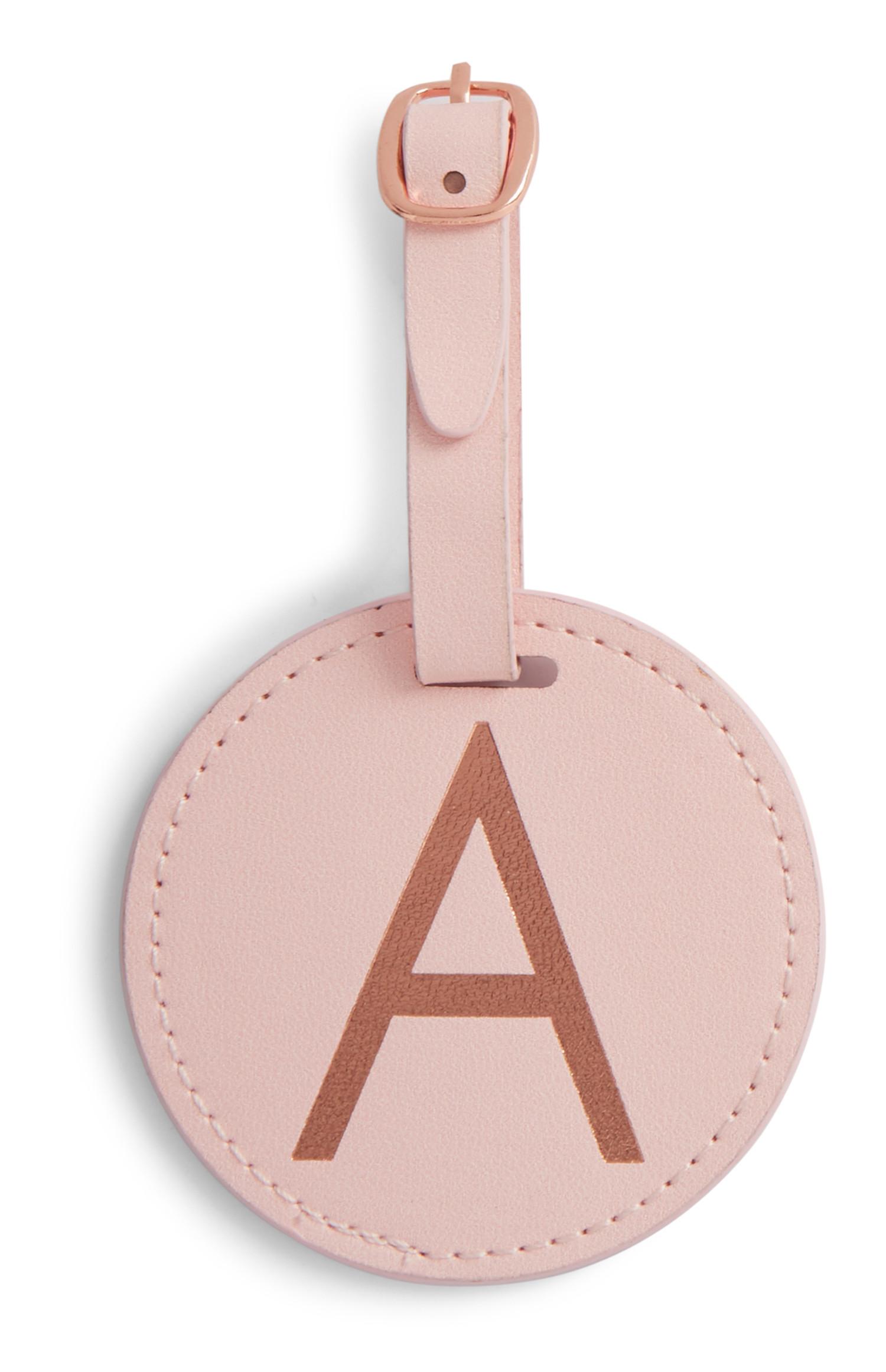 Etichetta bagaglio rosa con iniziale